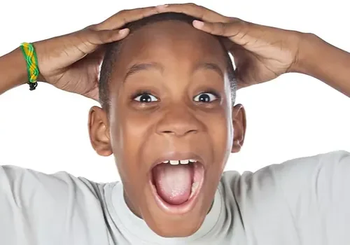 boy shouting madly with his hands over h