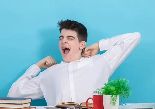 teen student yawning bored or tired at the desk